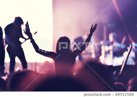 Crowd at a music concert, audience raising hands up 89552589