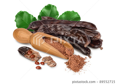 Carob pod and powder in wooden scoop isolated on white background with clipping path and full depth of field. 89552715