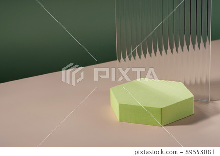 Acrylic ribbed plate, hexagon podium, background for cosmetic product packaging on green backdrop. Showcase for jewellery presentation, display for perfume advertising, cosmetics branding scene 89553081
