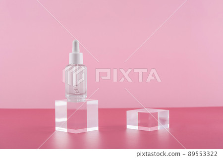 Serum cosmetic bottle with peptides and retinol on acrylic blocks on pink background. Cosmetics transparent product packaging with stylish props. Serum dropper mockup on pedestal podium 89553322