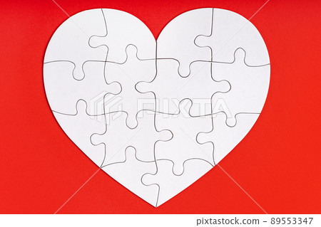 Jigsaw puzzle pieces in form of heart on red background. Love, charity, donation, helping concept. Perfect match Jigsaw puzzle pieces in form of heart on red background. Love, charity, donation, helping concept. Perfect match 89553347
