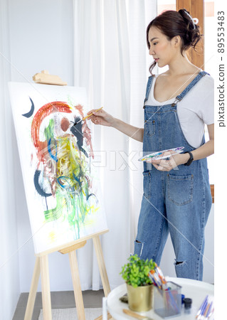 Female artist painting on canvas, Artist studio interior, Draw with watercolor, Drawing supplies , Painting and creativity, Use a brush to draw a pattern by stripes, Artwork, Using Paint Brush. 89553483