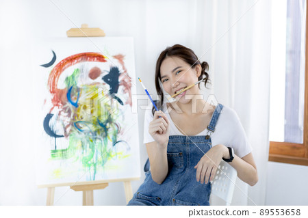 Female artist painting on canvas, Artist studio interior, Draw with watercolor, Drawing supplies , Painting and creativity, Use a brush to draw a pattern by stripes, Artwork, Using Paint Brush. 89553658