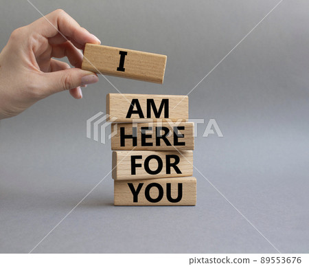 I am here for you symbol. Concept words I am here for you on wooden blocks. Beautiful grey background. Businessman hand. Business and I am here for you concept. Copy space. 89553676