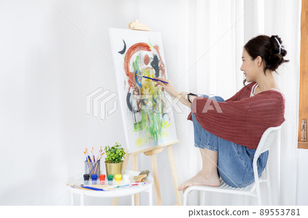 Female artist painting on canvas, Artist studio interior, Draw with watercolor, Drawing supplies , Painting and creativity, Use a brush to draw a pattern by stripes, Artwork, Using Paint Brush. Female artist painting on canvas, Artist studio interior, Draw with watercolor, Drawing supplies , Painting and creativity, Use a brush to draw a pattern by stripes, Artwork, Using Paint Brush. 89553781