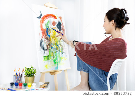 Female artist painting on canvas, Artist studio interior, Draw with watercolor, Drawing supplies , Painting and creativity, Use a brush to draw a pattern by stripes, Artwork, Using Paint Brush. Female artist painting on canvas, Artist studio interior, Draw with watercolor, Drawing supplies , Painting and creativity, Use a brush to draw a pattern by stripes, Artwork, Using Paint Brush. 89553782