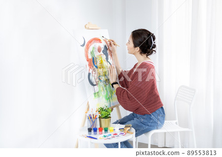 Female artist painting on canvas, Artist studio interior, Draw with watercolor, Drawing supplies , Painting and creativity, Use a brush to draw a pattern by stripes, Artwork, Using Paint Brush. 89553813