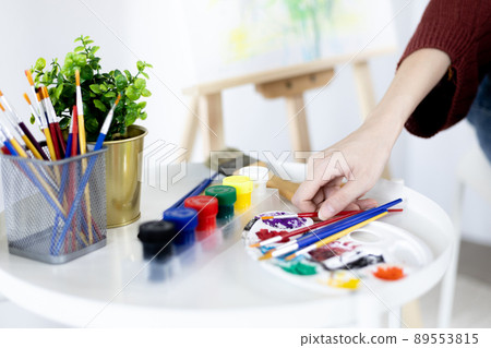 Female artist painting on canvas, Artist studio interior, Draw with watercolor, Drawing supplies , Painting and creativity, Use a brush to draw a pattern by stripes, Artwork, Using Paint Brush. Female artist painting on canvas, Artist studio interior, Draw with watercolor, Drawing supplies , Painting and creativity, Use a brush to draw a pattern by stripes, Artwork, Using Paint Brush. 89553815