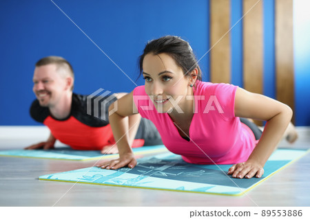 Smiling man and woman doing exercise for fit body goal, active train in morning 89553886