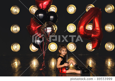 Birthday baloons for party and celebrations. ballons abstract decoration. Girl dressed in rock style. rock girl celebrating birthday. the girl drinks. the little girl is four years old. 89553999