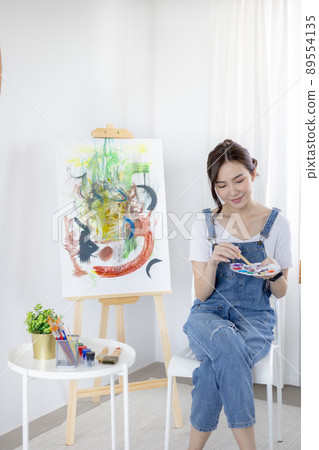 Female artist painting on canvas, Artist studio interior, Draw with watercolor, Drawing supplies , Painting and creativity, Use a brush to draw a pattern by stripes, Artwork, Using Paint Brush. 89554135