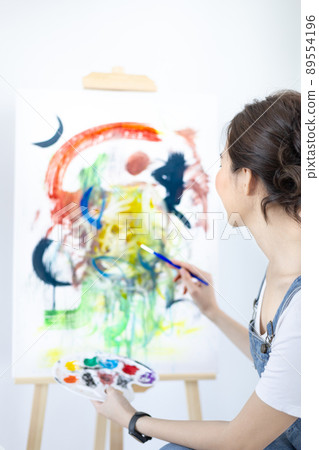 Female artist painting on canvas, Artist studio interior, Draw with watercolor, Drawing supplies , Painting and creativity, Use a brush to draw a pattern by stripes, Artwork, Using Paint Brush. Female artist painting on canvas, Artist studio interior, Draw with watercolor, Drawing supplies , Painting and creativity, Use a brush to draw a pattern by stripes, Artwork, Using Paint Brush. 89554196