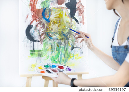 Female artist painting on canvas, Artist studio interior, Draw with watercolor, Drawing supplies , Painting and creativity, Use a brush to draw a pattern by stripes, Artwork, Using Paint Brush. 89554197