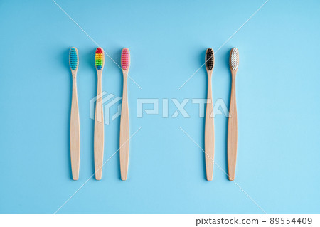 A bunch of eco-friendly bamboo toothbrushes. Global environmental trends. Gender and racial inequality. Toothbrushes of different genders 89554409
