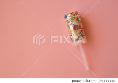 Multicolored candy in a package on a pink background. Candy is the best decor for your merry holiday Multicolored candy in a package on a pink background. Candy is the best decor for your merry holiday 89554550