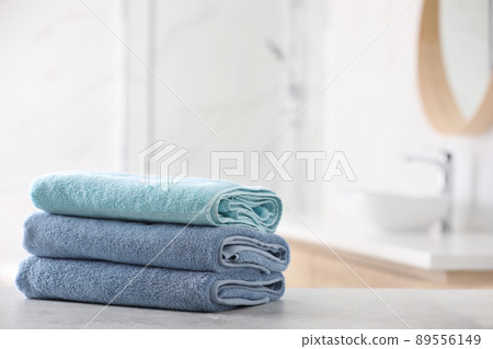Stack of fresh towels on table in bathroom. Space for text Stack of fresh towels on table in bathroom. Space for text 89556149