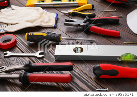 Different modern construction tools on wooden background 89556171