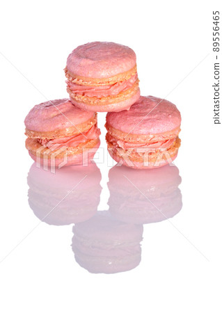 Three pink macarons on glossy white background Three pink macarons on glossy white background 89556465