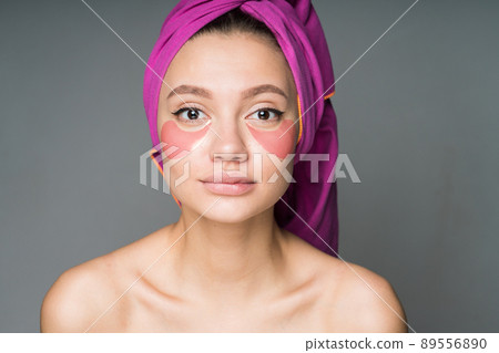 wrapping her head with a tighter girl with hugging shoulders pasted patches under her eyes 89556890