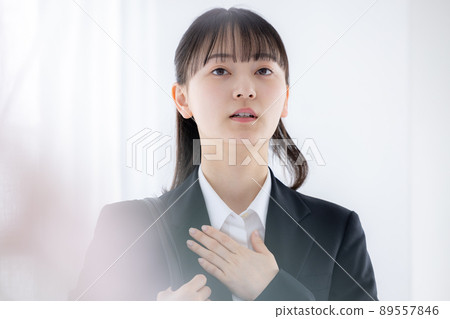 Job hunting woman who is nervous with her hand on her chest 89557846