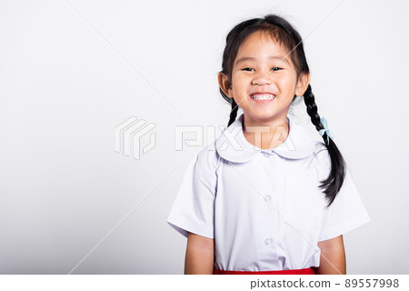 Asian adorable toddler smiling happy wearing student thai uniform standing 89557998