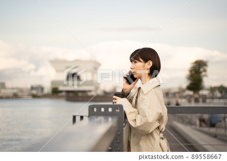 A woman talking on a smartphone A woman talking on a smartphone 89558667