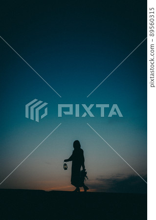 Female silhouette and beautiful sunset sky Female silhouette and beautiful sunset sky 89560315