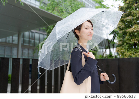 Women with an umbrella in the rain Business Women with an umbrella in the rain Business 89560638