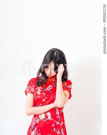 Portrait of Young asian woman wearing traditional cheongsam qipao dress thinking with hand on head isolated over white background. Portrait of Young asian woman wearing traditional cheongsam qipao dress thinking with hand on head isolated over white background. 89562156