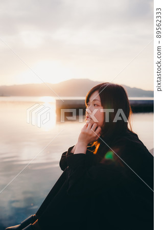 Beautiful sunset sky with a woman Beautiful sunset sky with a woman 89562333