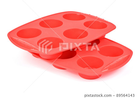 Red silicone form for cooking muffin and cupcake on white background. Side view. High resolution photo. 89564143