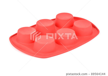 Red silicone form for cooking muffin and cupcake on white background. Side view. High resolution photo. 89564144
