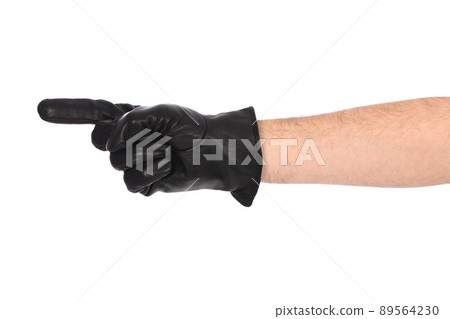 Man wearing black leather glove on white background. Close-up black leather glove showing thumbs up, number one. 89564230