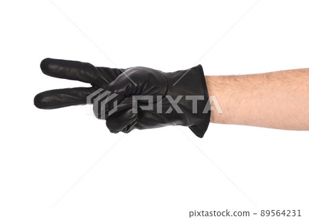 Man wearing black leather glove on white background, closeup. Two fingers forward. 89564231
