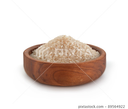 Uncooked Dry Rice in Wooden Bowl on White Background. File with Clipping Path. Uncooked Dry Rice in Wooden Bowl on White Background. File with Clipping Path. 89564922