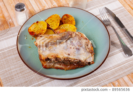 Appetizing baked pork ribs with fried sliced potatoes 89565636