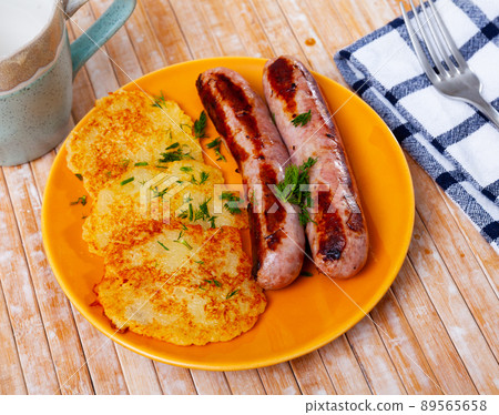 Fried potato pancakes with grilled pork sausages Fried potato pancakes with grilled pork sausages 89565658