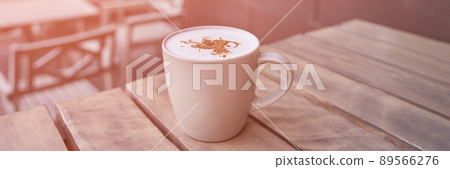 drinking coffee in outdoor cafe. Tasty latte in mug. Lunch casual atmosphere drinking coffee in outdoor cafe. Tasty latte in mug. Lunch casual atmosphere 89566276