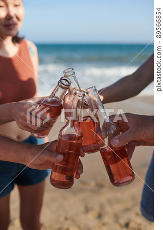 Friends Toasting with Glass Bottles 89566854