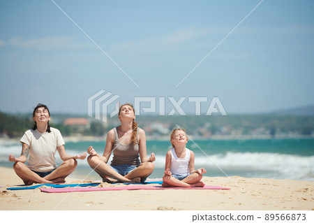 People Meditating on Beach People Meditating on Beach 89566873