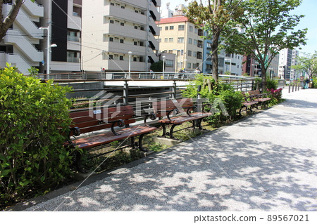 Bench along the sidewalk Bench along the sidewalk 89567021