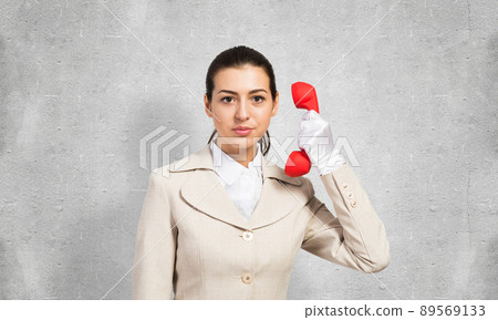 Beautiful business woman with vintage red phone 89569133