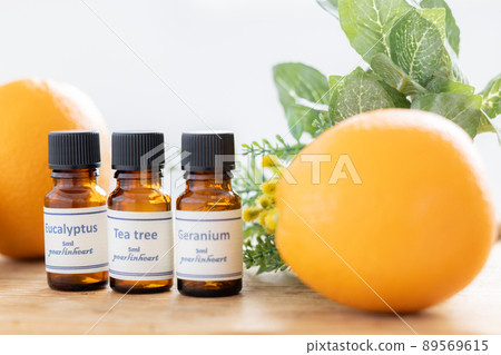 Aroma oil bottle and fruit (orange and lemon) 89569615