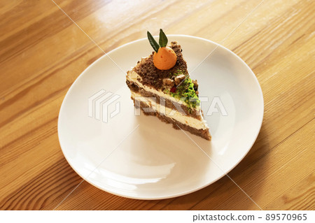 Piece of carrot cake on plate on wooden table Piece of carrot cake on plate on wooden table 89570965
