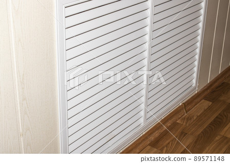 White radiator grill on the wall closeup 89571148