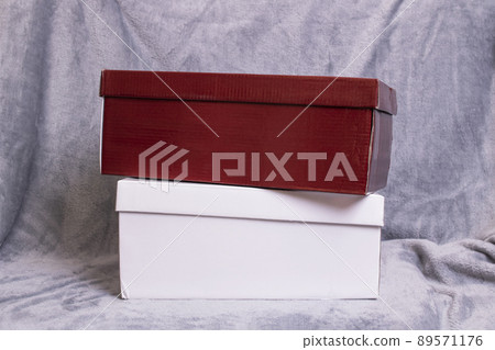 Two cardboard boxes on a gray background Two cardboard boxes on a gray background 89571176