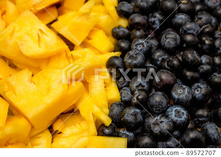 Fresh fruits background, Tropical fruit and berries are consisted of slice pineapple and blueberry Fresh fruits background, Tropical fruit and berries are consisted of slice pineapple and blueberry 89572707