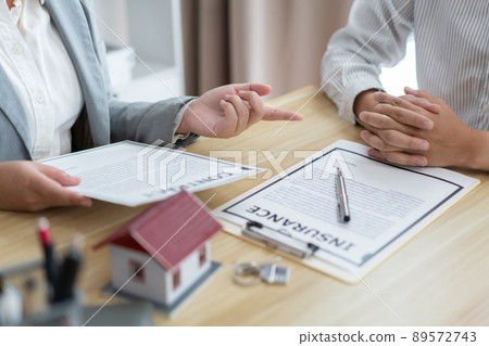 Insurance concept the broker explaining the agreement of the contract to his customer Insurance concept the broker explaining the agreement of the contract to his customer 89572743