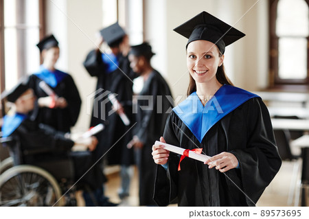 Young Woman wearing Graduation Robe 89573695
