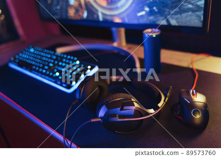 Professional gaming setup in neon lights laying on desktop 89573760